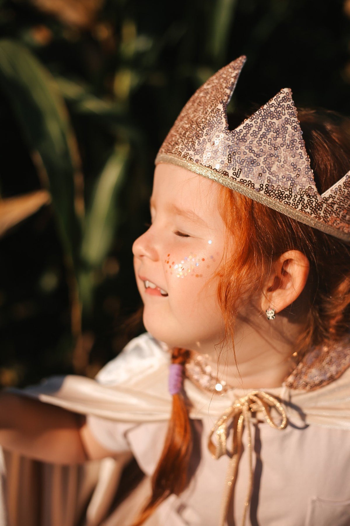 6. Close-up of girl in cream cape wearing glittery crown