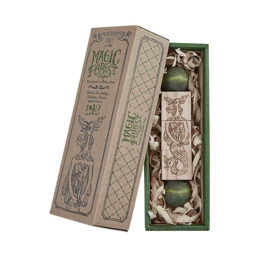 9. Magic Forest wooden spinning puzzle in an open box with green accents and engraved designs