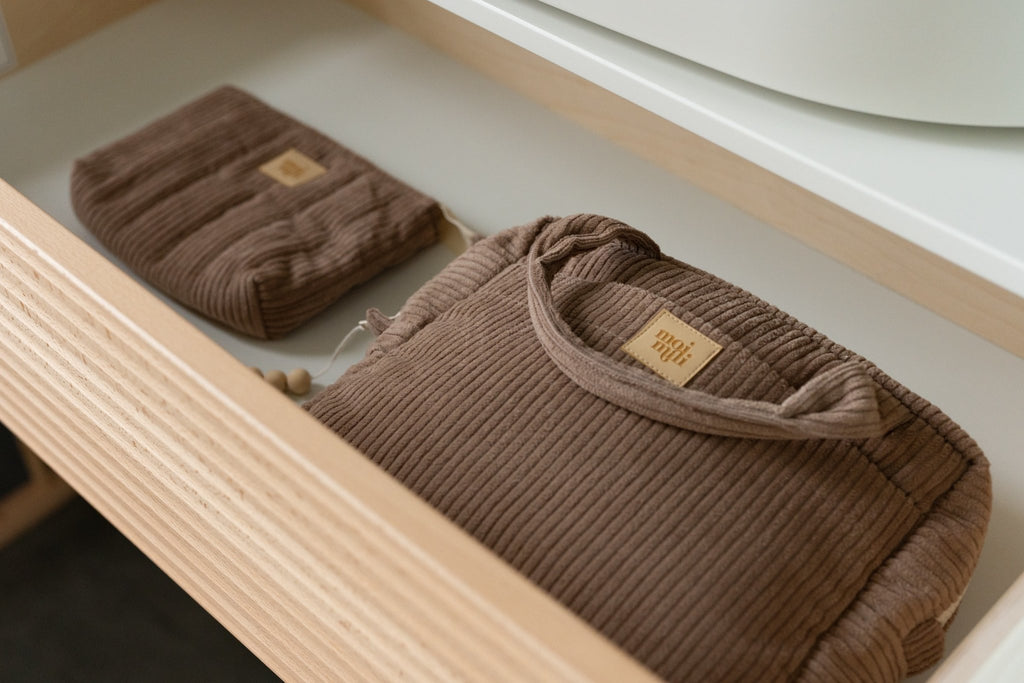 5. Latte-colored makeup bag set of two in a drawer, showing large and small bags with Moi Mili logo, highlighting storage capability.