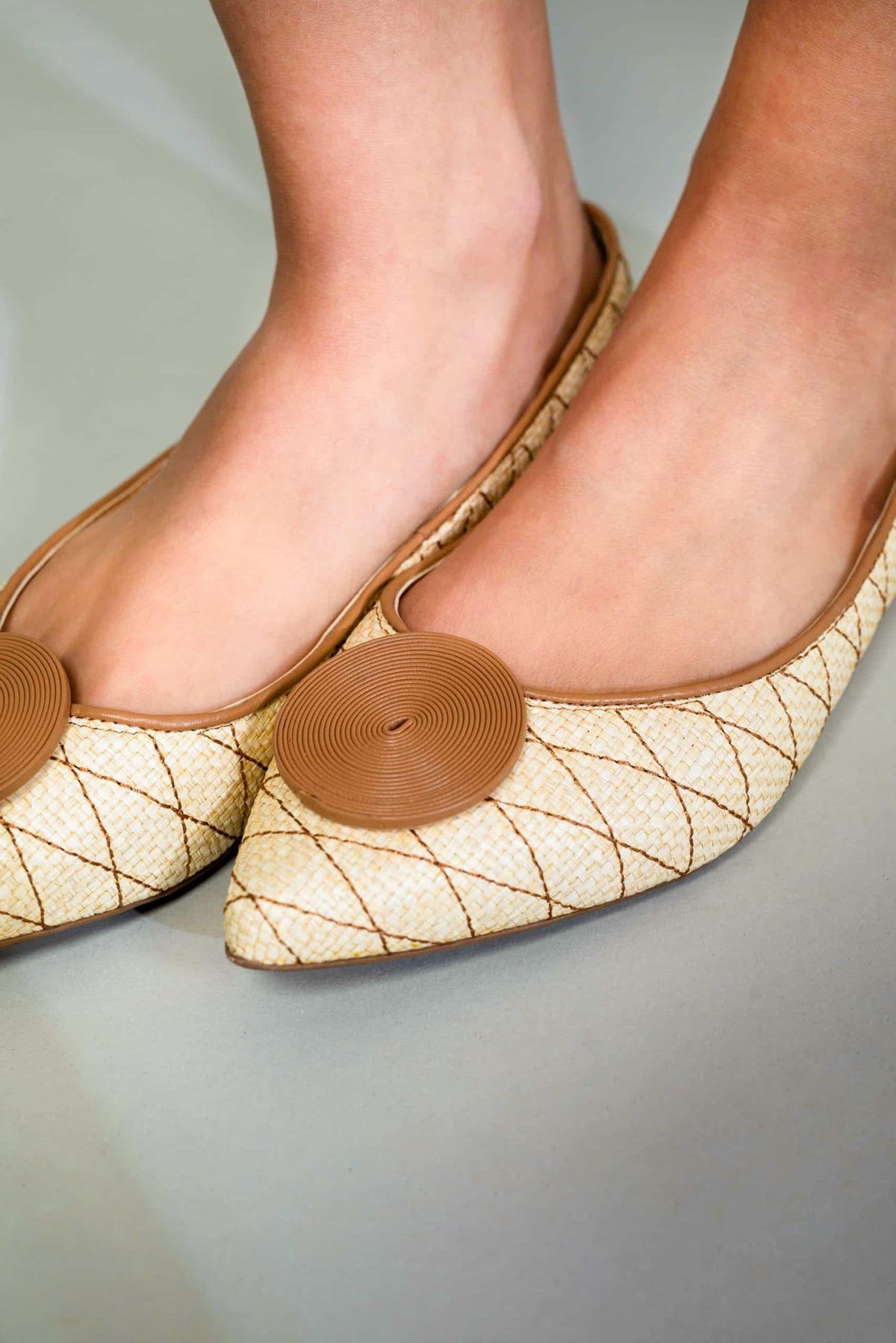 5. Close-up of Mangará Coroba Ballerinas on woman's feet, emphasizing textured circle embellishment