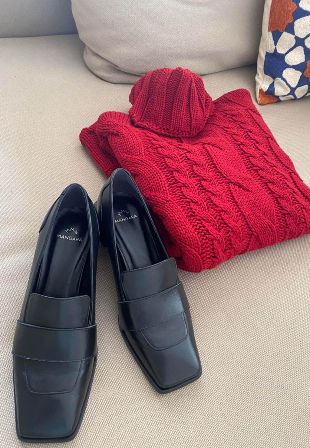 7. Women's black Mangará Louro Leather Loafers styled with red knitwear in lifestyle setting
