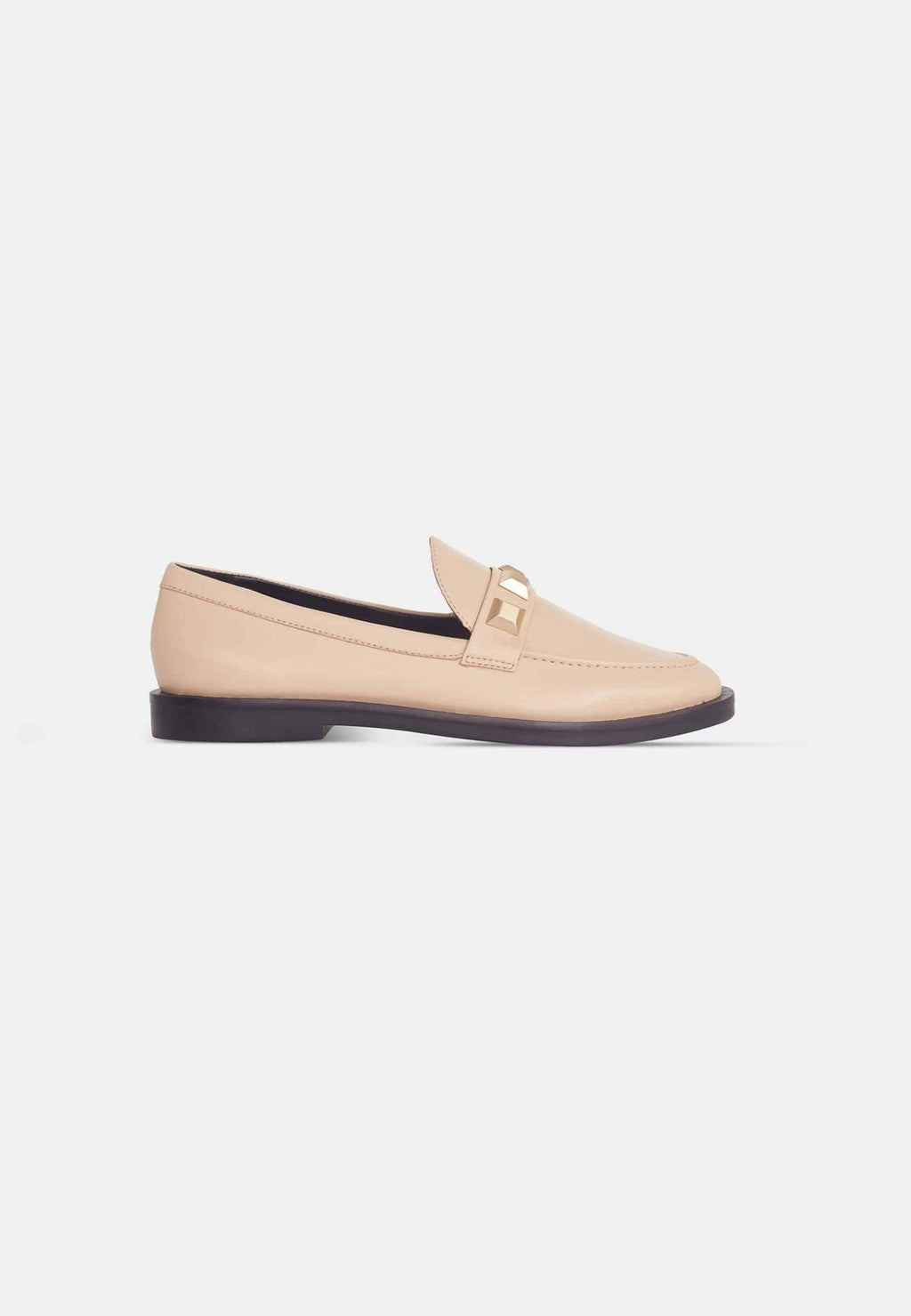 12. Angled view of beige Mangará Caete leather loafers with metal studs, studio setting