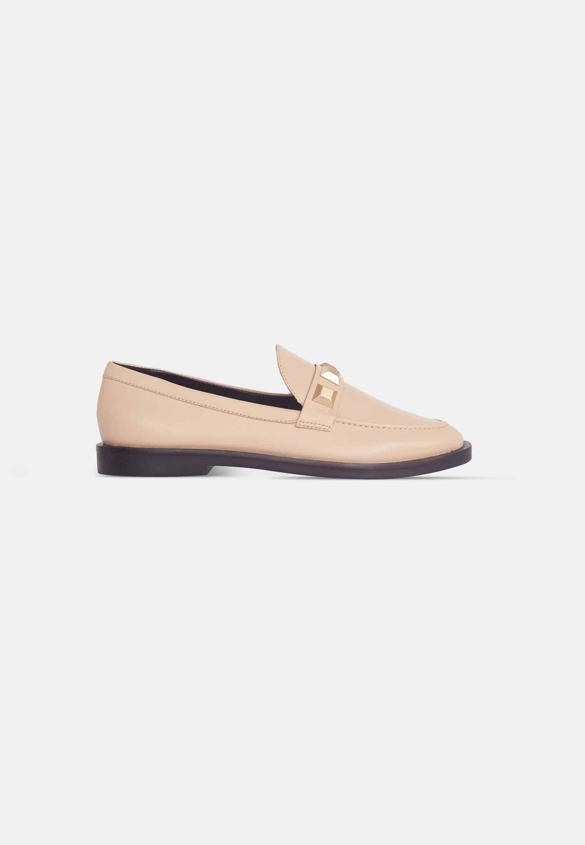 12. Angled view of beige Mangará Caete leather loafers with metal studs, studio setting