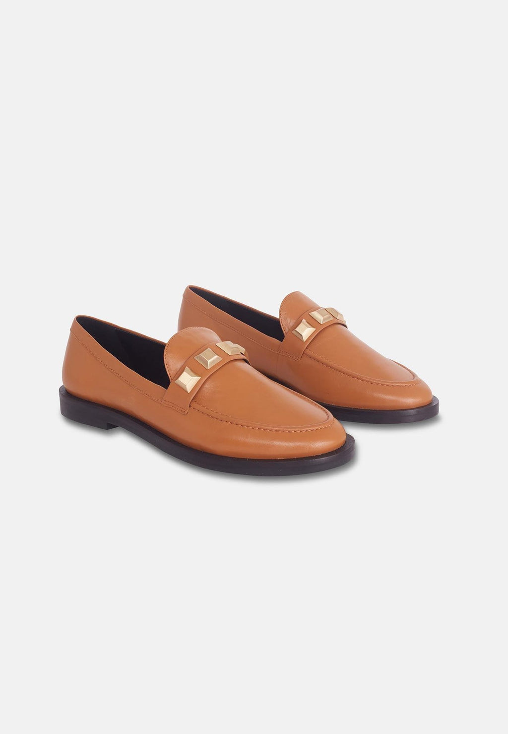 11. Angled view of brown Mangará Caete leather loafers with metal studs, studio setting