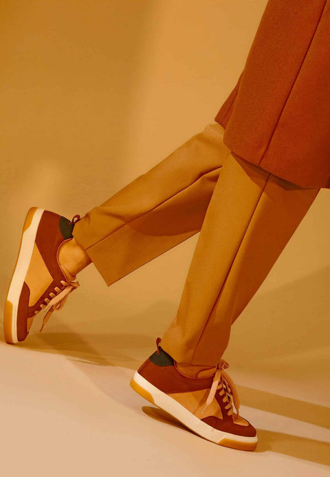 2. Women's Allamanda sneakers by Mangará in multicolored suede, shown in a lifestyle setting with model