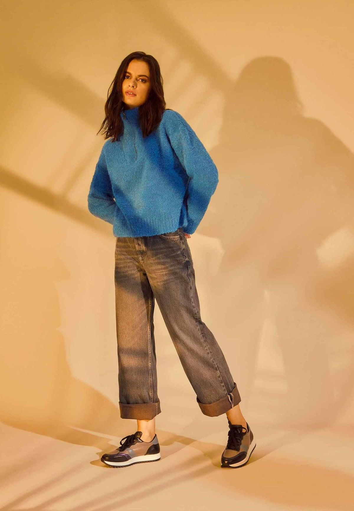 2. Women's Mangará Buriri sneakers styled with blue sweater and rolled jeans in lifestyle setting