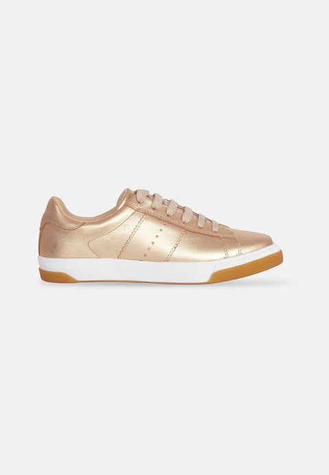 4. Side view of Mangará women's metallic golden leather sneakers with rubber outsole in studio