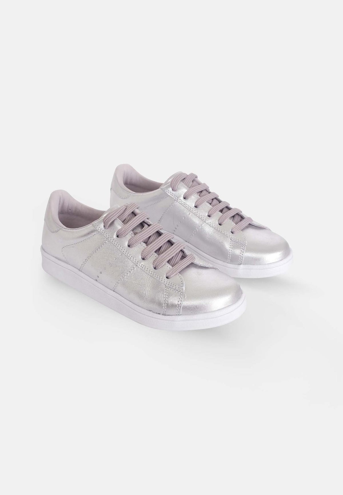 3. Pair of Mangará women's metallic silver leather sneakers in studio setting, highlighting sleek design