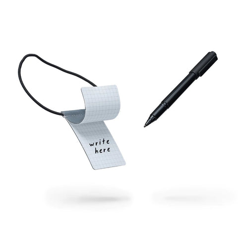 3. MARCH Reflective Luggage Tag with writable surface and pen, showcasing usability