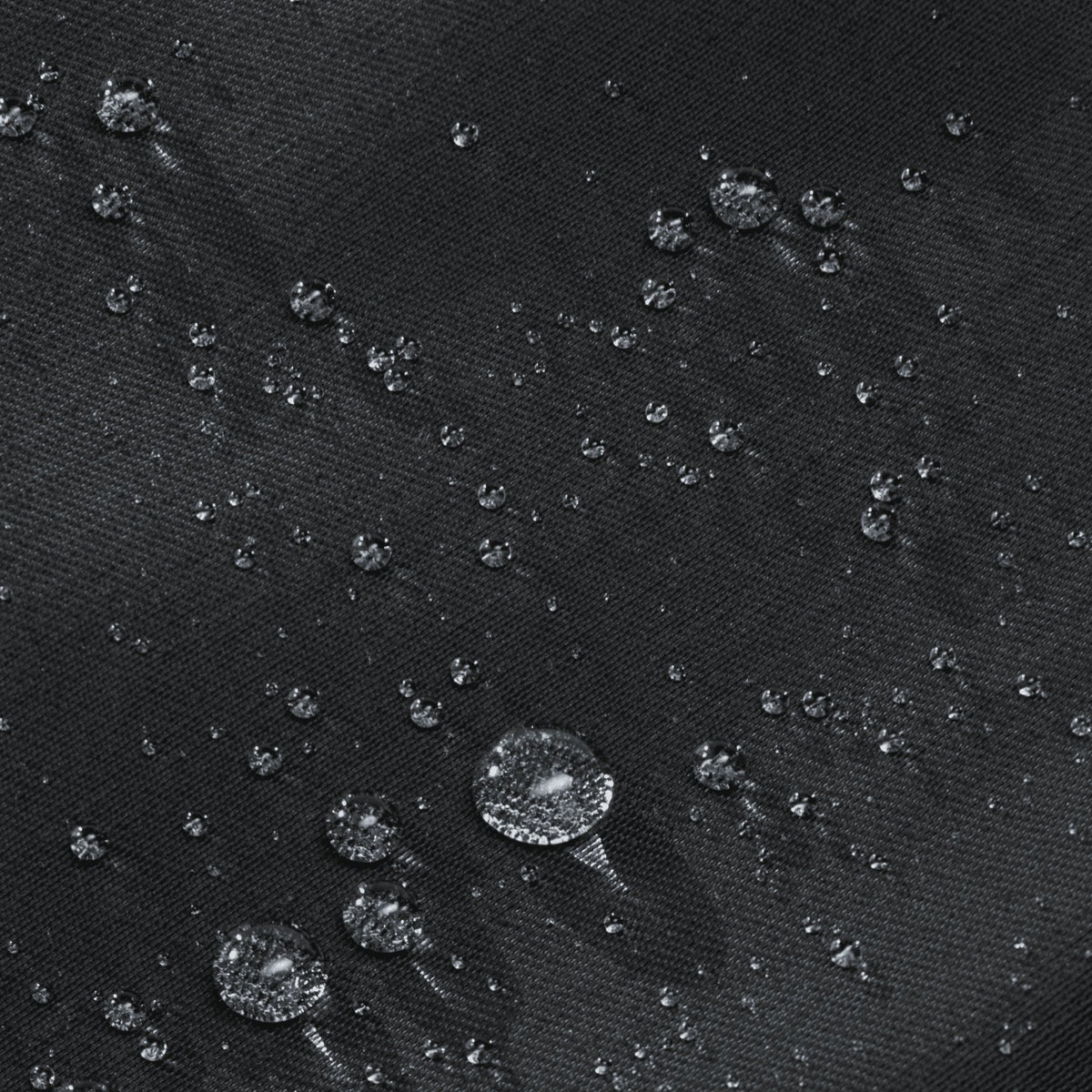 5. Close-up of water droplets on black fabric of March Design Studio's Water Resistant Reflective Backpack DOT, highlighting water-resistant feature