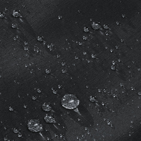 5. Close-up of water droplets on black fabric of March Design Studio's Water Resistant Reflective Backpack DOT, highlighting water-resistant feature