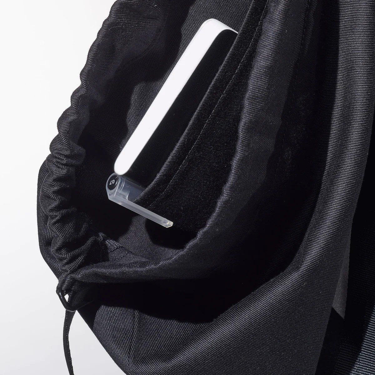 4. Close-up of inside pocket of MARCH Water Resistant Reflective Backpack QR, showing organization feature