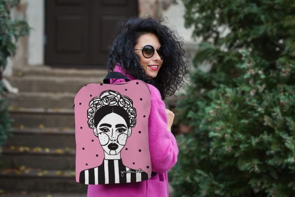 1. Women's pink MARGO backpack by Garbanota with artistic print, worn by model in outdoor setting