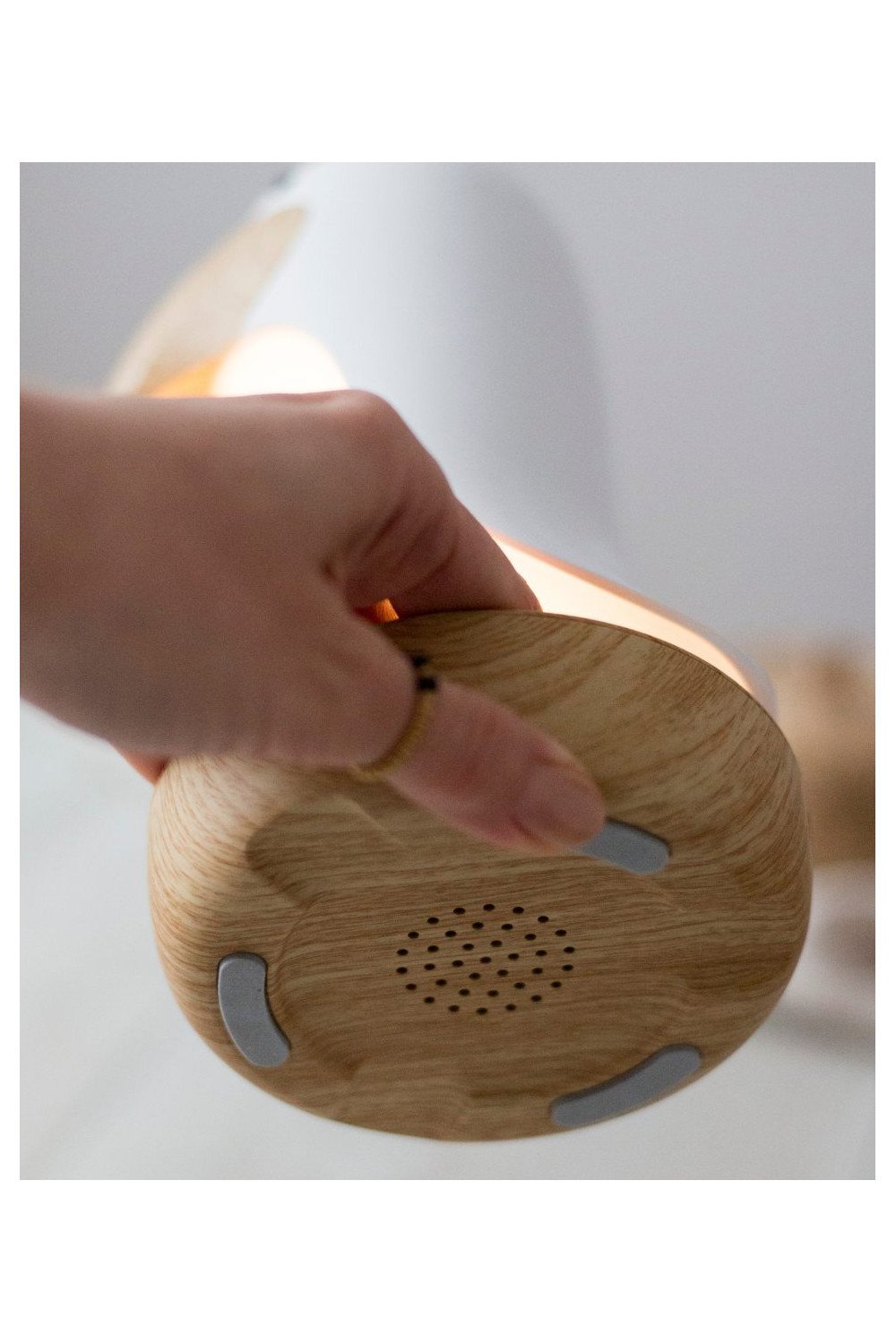 3. Close-up of speaker holes on bottom of bird lamp's wooden base