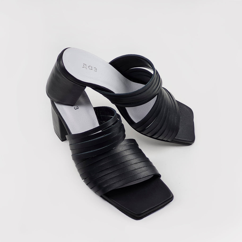 5. Angled view of women's black leather sandals with strappy design and squared toe