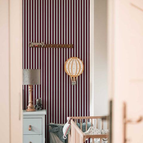 1. Children's room with brown and blue striped wallpaper by Dekornik, featuring a crib, lamp, and decorative wooden sword and hot air balloon