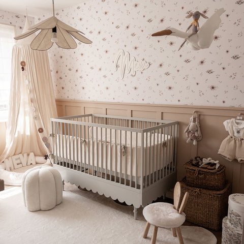 5. Nursery with a grey crib and Dekornik's Flowers Minimini Wallpaper featuring soft floral patterns on the walls