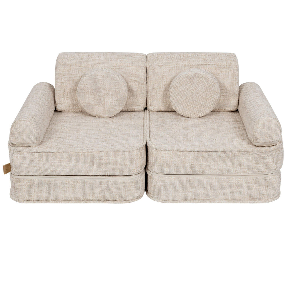 2. Beige modular children's sofa with round cushions, shown in a studio setting