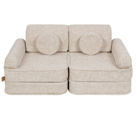2. Beige modular children's sofa with round cushions, shown in a studio setting