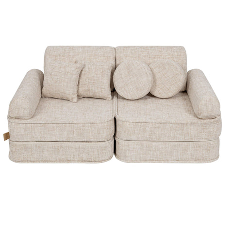 1. Beige modular children's sofa with round and square cushions, shown in a studio setting