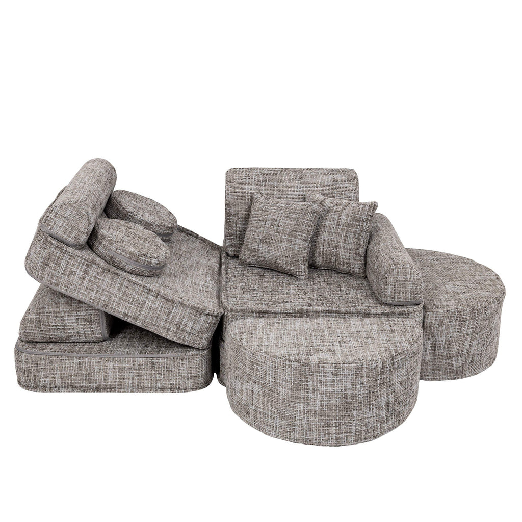 7. Grey modular children's sofa with cushions in a layered and dynamic setup on a white background