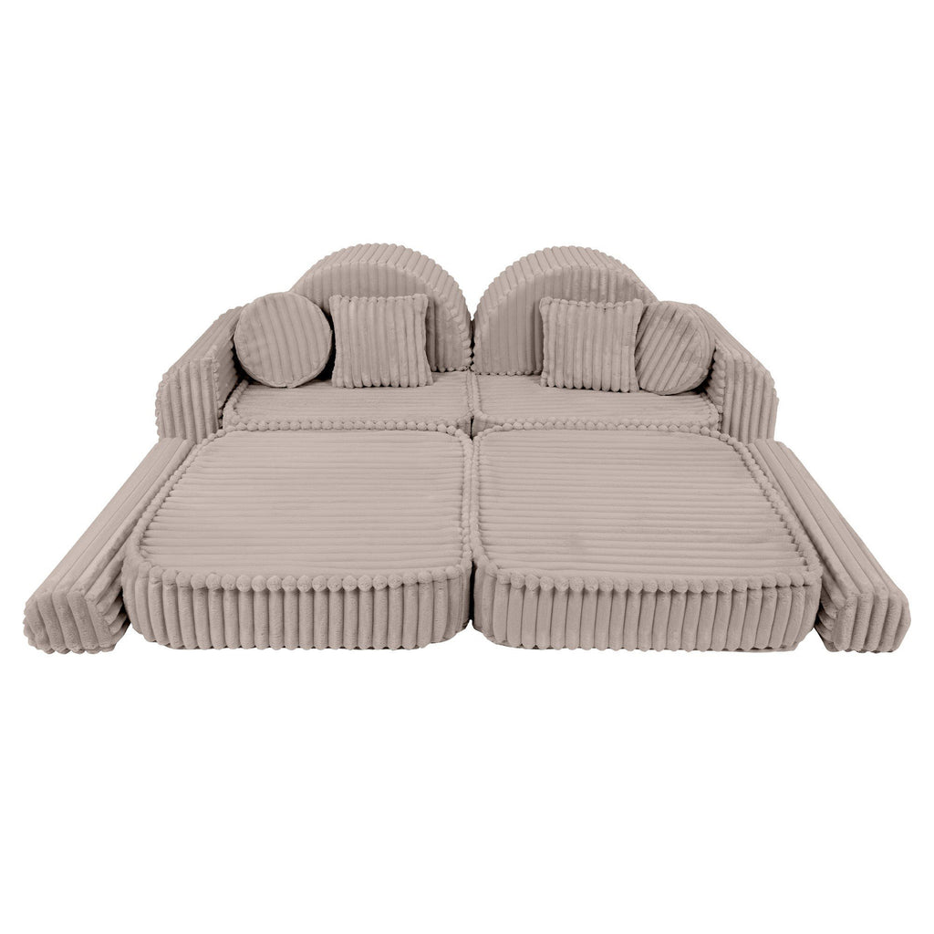 3. Beige modular kids sofa laid flat with ribbed corduroy texture, featuring round cushions and armrests
