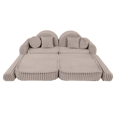 3. Beige modular kids sofa laid flat with ribbed corduroy texture, featuring round cushions and armrests