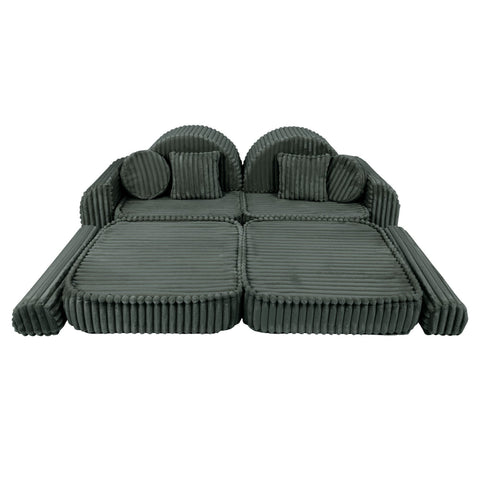 2. Medium modular kids sofa in forest green corduroy, laid flat with ribbed texture, showcasing versatility and comfort.