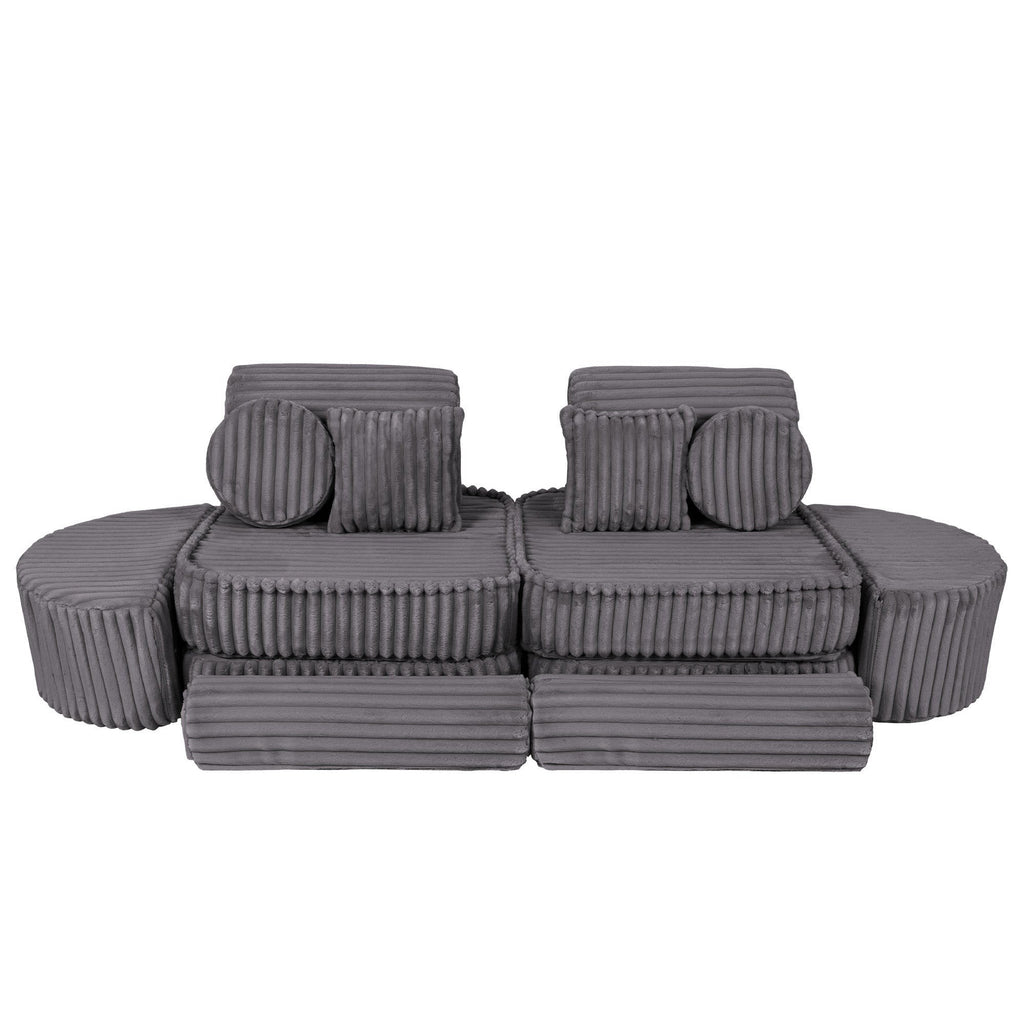 2. Grey modular kids sofa with ribbed texture, featuring two back cushions and round pillows, arranged in a linear layout