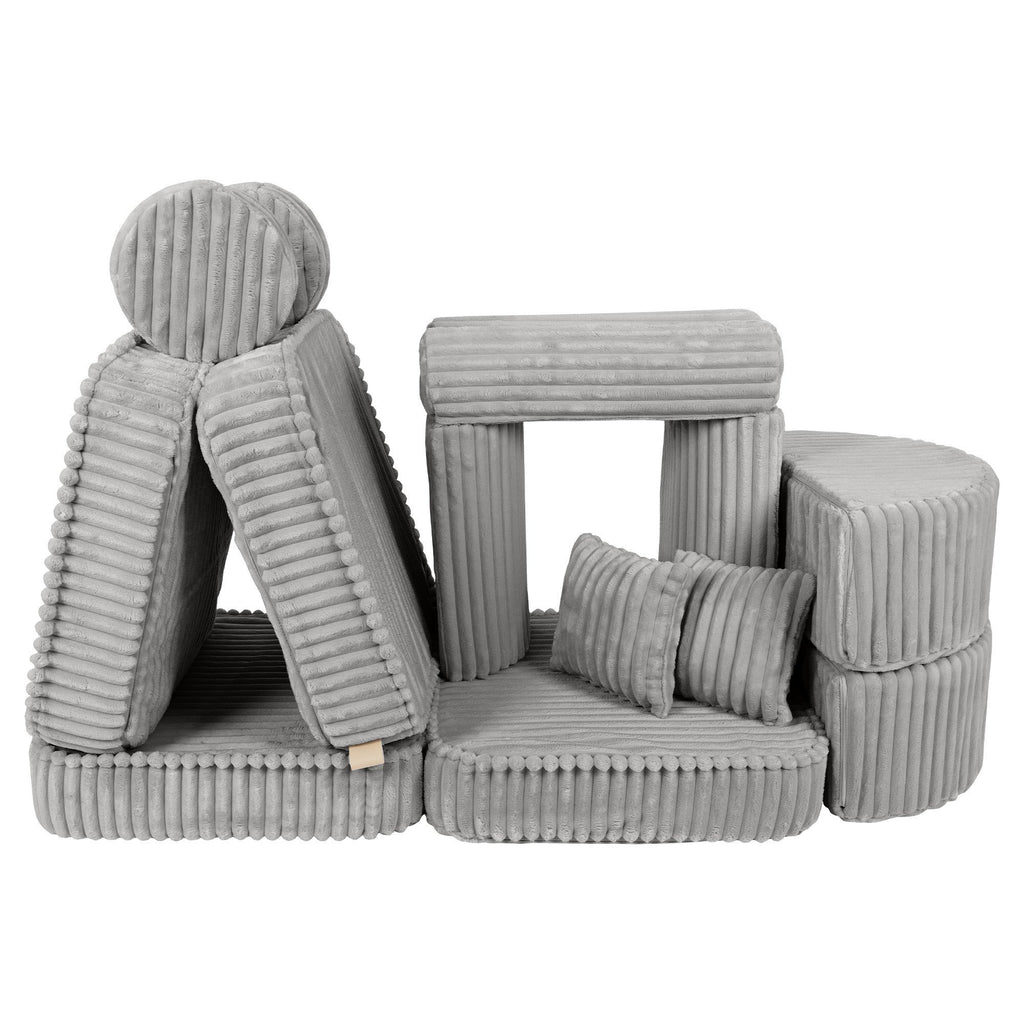 2. Versatile kids sofa in moon grey corduroy, displayed in a playful, stacked arrangement with cushions and armrests
