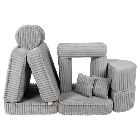 2. Versatile kids sofa in moon grey corduroy, displayed in a playful, stacked arrangement with cushions and armrests