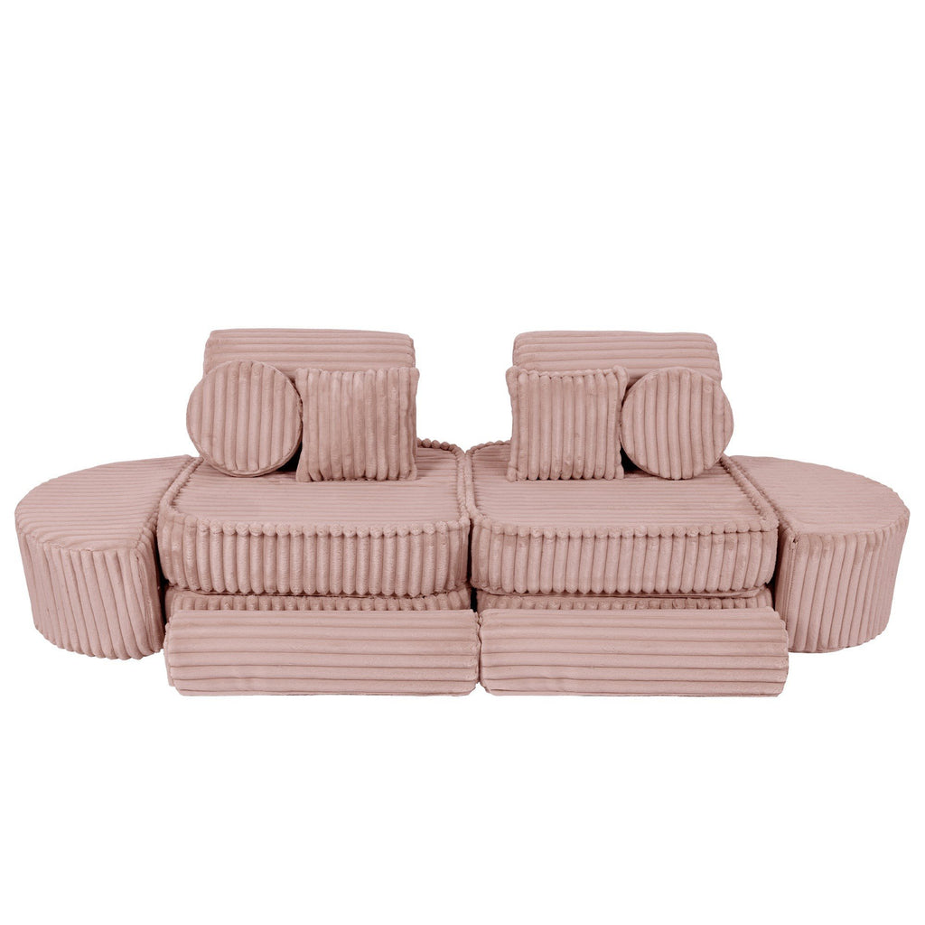13. Medium modular kids sofa in churros pink with ribbed corduroy fabric, featuring two back cushions and circular armrests, arranged symmetrically.