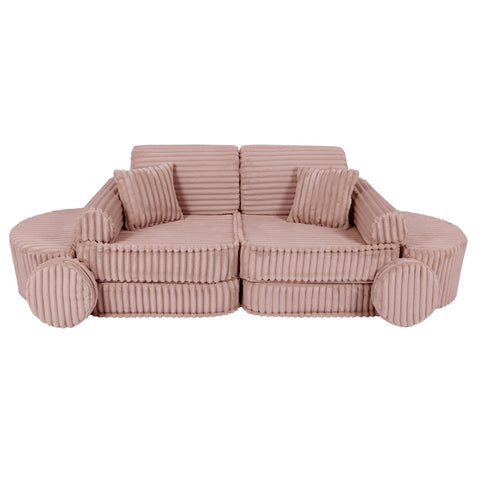 2. Medium modular kids sofa in churros pink with ribbed corduroy fabric, showcasing two back cushions and circular armrests, arranged in a symmetrical design.