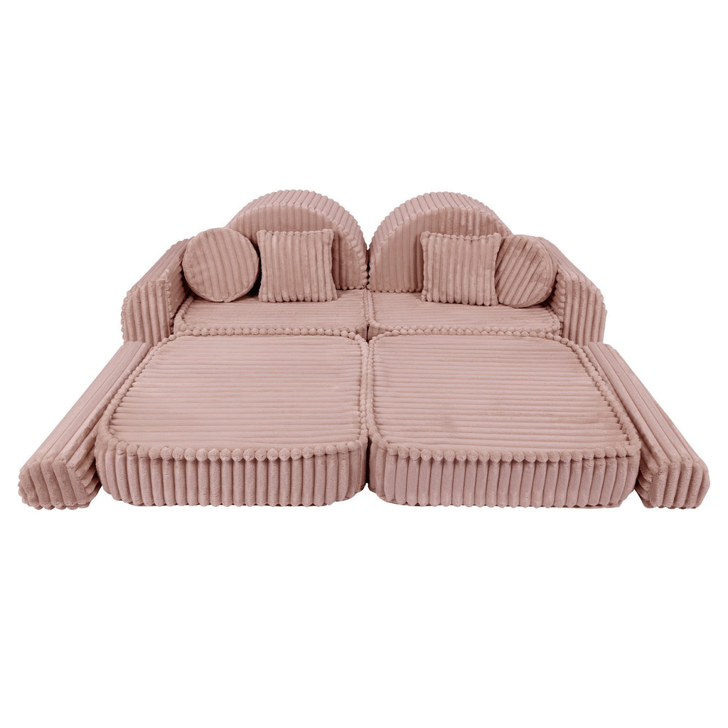 11. Medium modular kids sofa in churros pink with ribbed corduroy fabric, shown in a flat, extended layout with circular cushions.