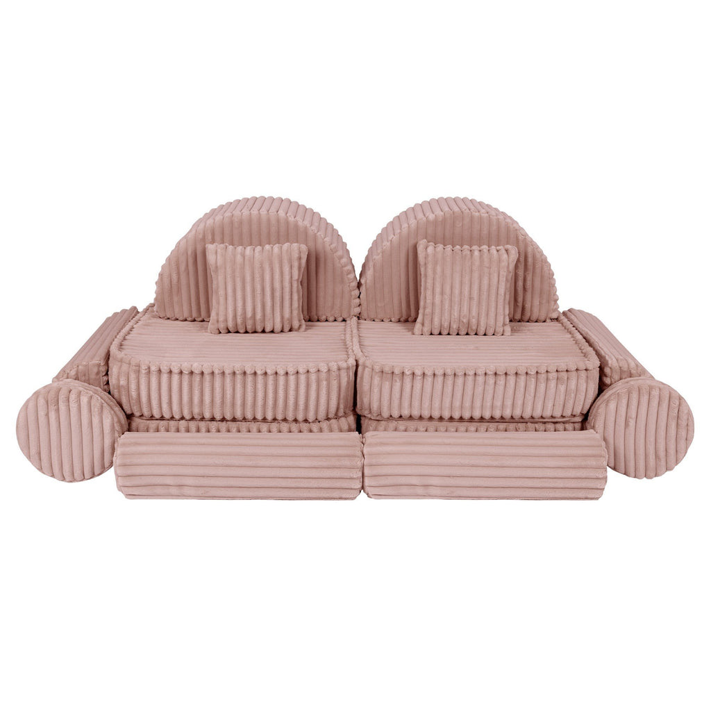 10. Medium modular kids sofa in churros pink with ribbed corduroy fabric, featuring two back cushions and circular armrests, arranged symmetrically.