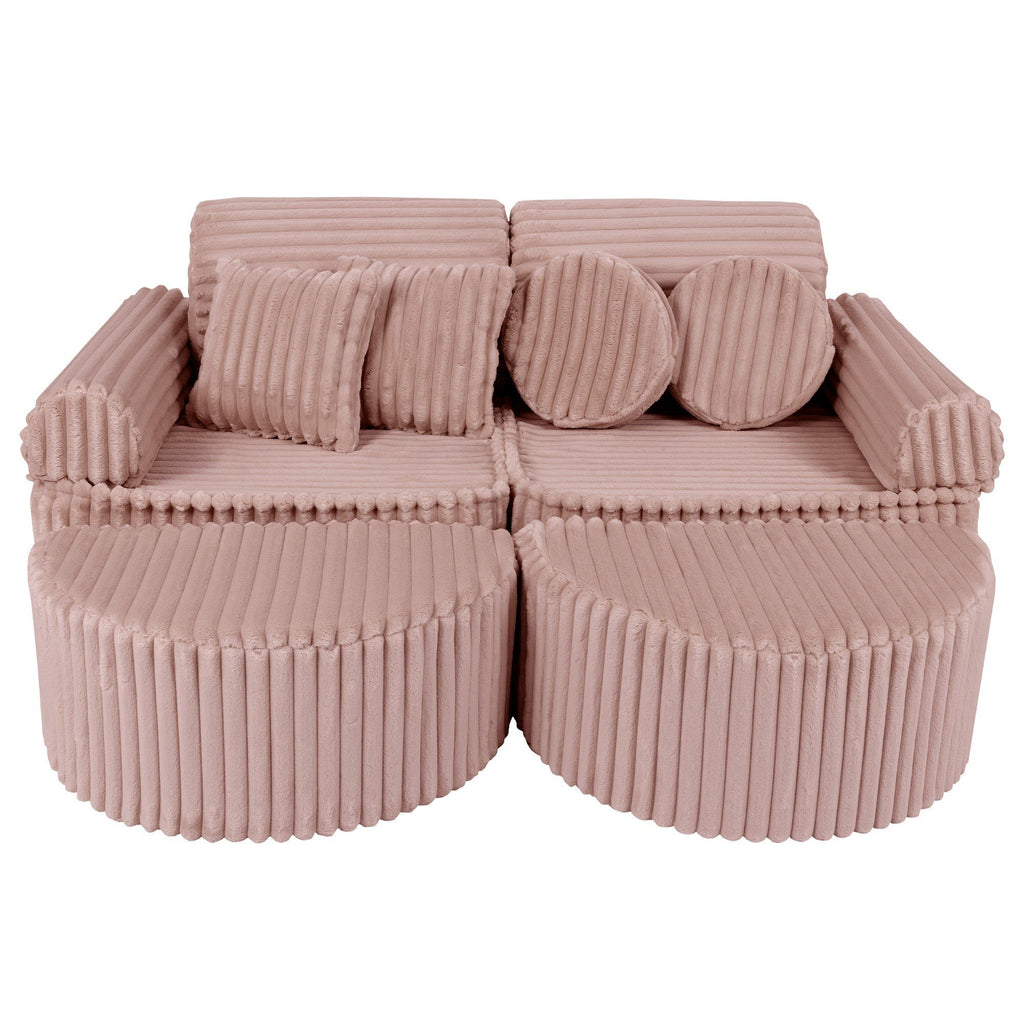 1. Medium modular kids sofa in churros pink with ribbed corduroy fabric, featuring two back cushions and circular armrests, arranged in a compact layout.