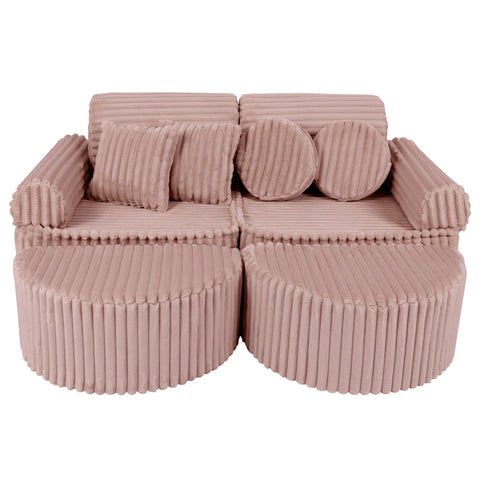 1. Medium modular kids sofa in churros pink with ribbed corduroy fabric, featuring two back cushions and circular armrests, arranged in a compact layout.