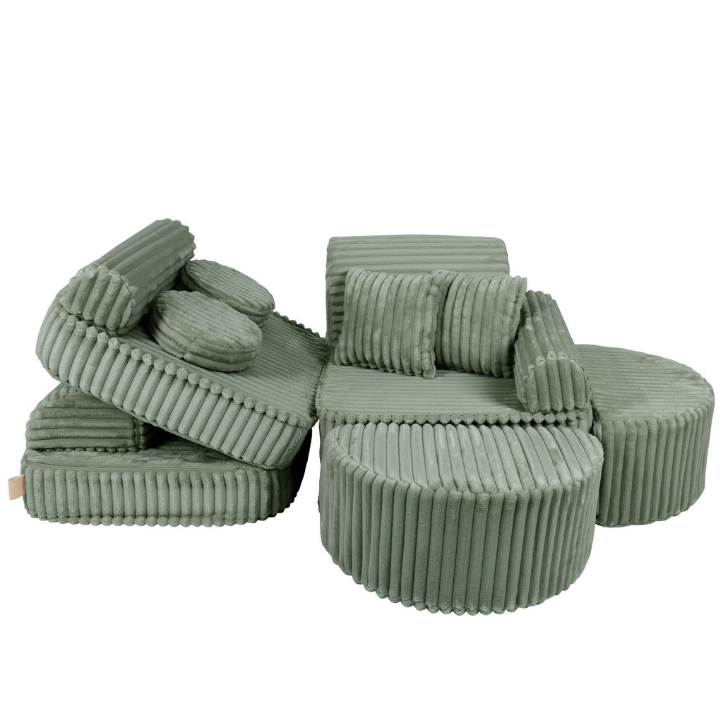 2. Medium modular kids sofa in sage green corduroy with ribbed texture, shown in a playful, disassembled layout with cushions.