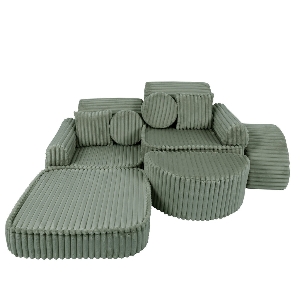 2. Medium modular kids sofa in sage green corduroy with ribbed texture, shown in a versatile layout with extended seating and cushions.