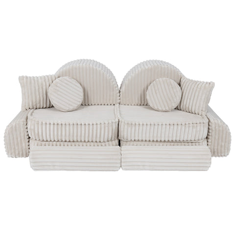 3. Medium kids sofa in churros white with ribbed corduroy fabric, featuring two seats and round cushions, arranged in a symmetrical layout.