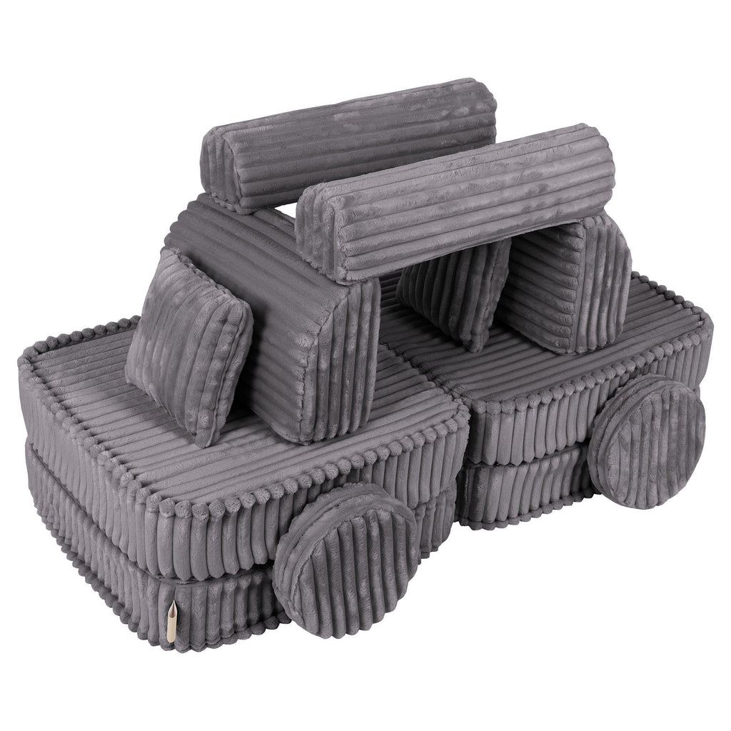 3. Medium modular kids sofa in Jurassic grey, creatively arranged in a playful structure with ribbed corduroy texture.