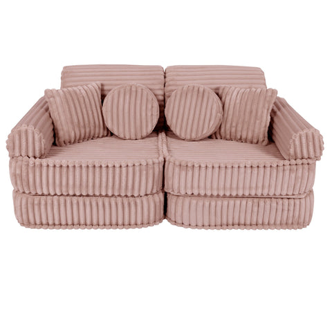 1. Medium modular kids sofa in churros pink with ribbed corduroy texture, featuring two round and two square cushions, shown in a compact configuration