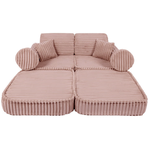 2. Medium modular kids sofa in churros pink with ribbed corduroy texture, laid flat with round and square cushions for lounging