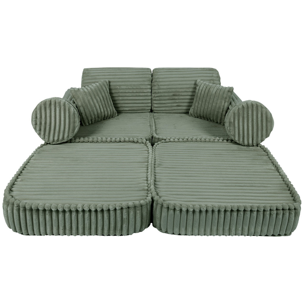 8. Medium kids sofa in sage green ribbed corduroy, fully extended to show spacious lounging area with round cushions