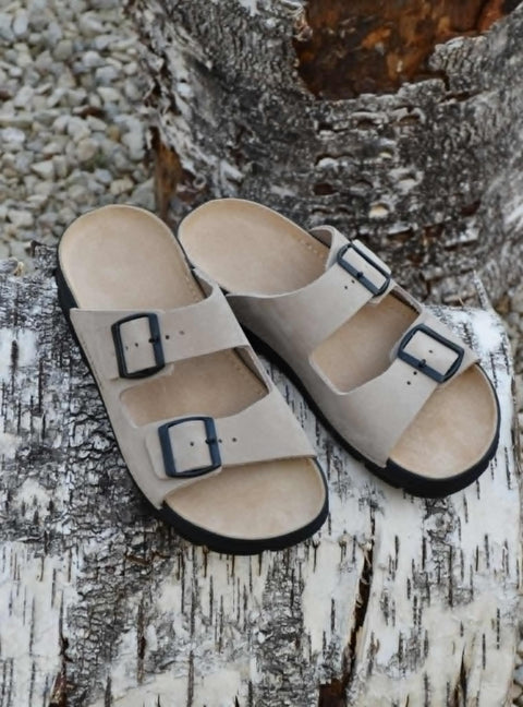 3. Omaking Meeliku beige leather sandals with adjustable buckle straps on a rustic surface