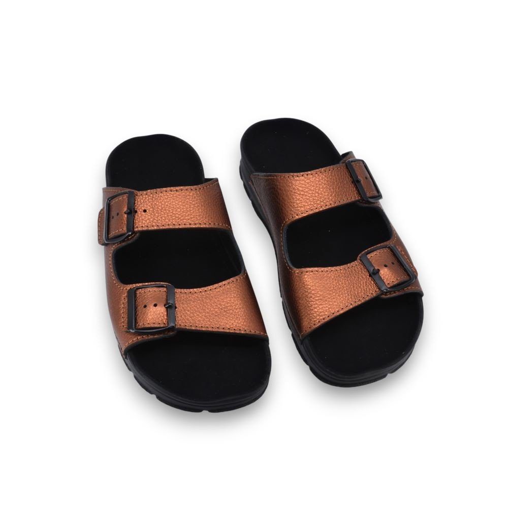 2. Pair of Omaking Meeliku women's bronze leather sandals with black insole, displayed in studio