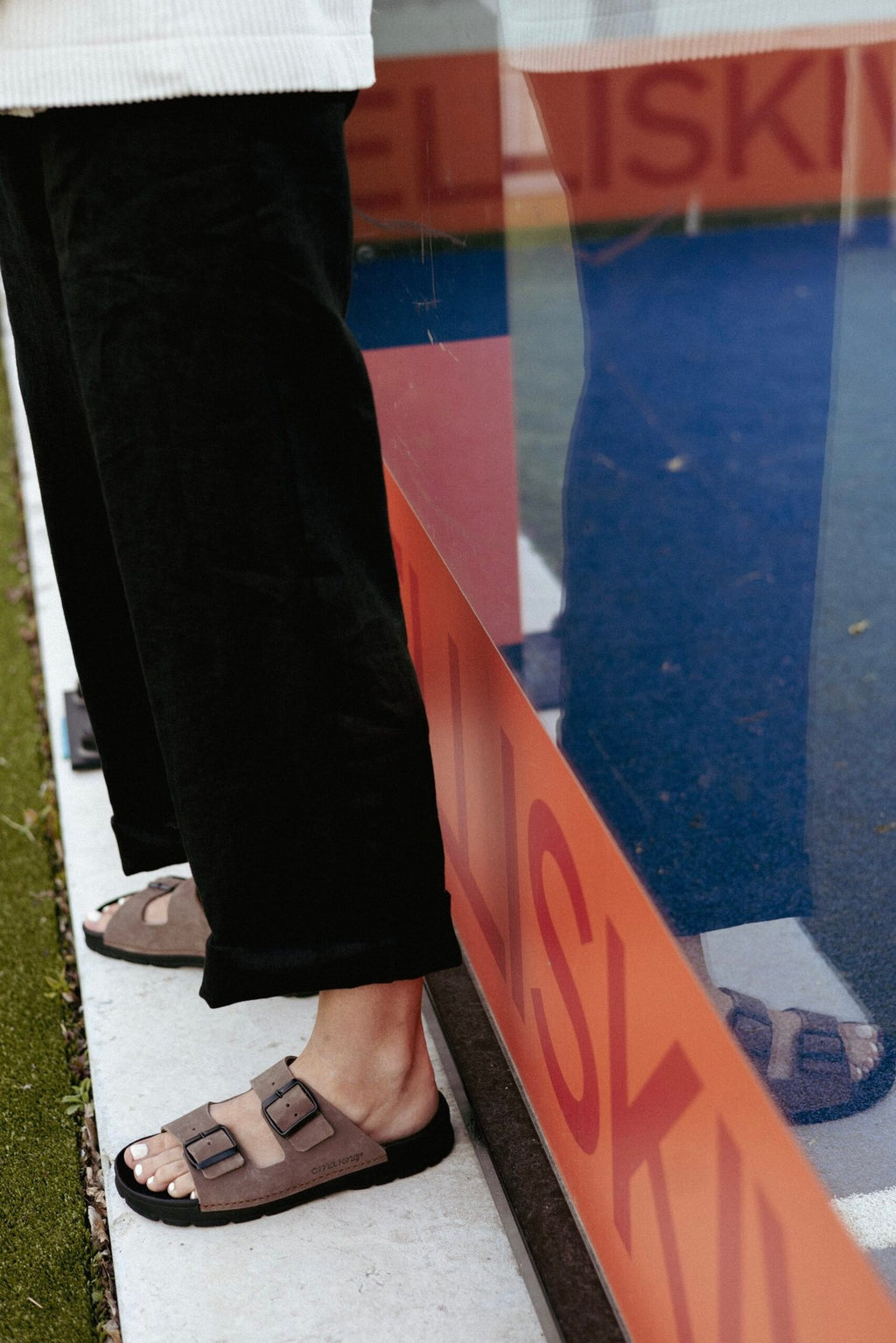 1. Women's Meeliku leather sandals in brown and black by OmaKing, worn outdoors with black pants
