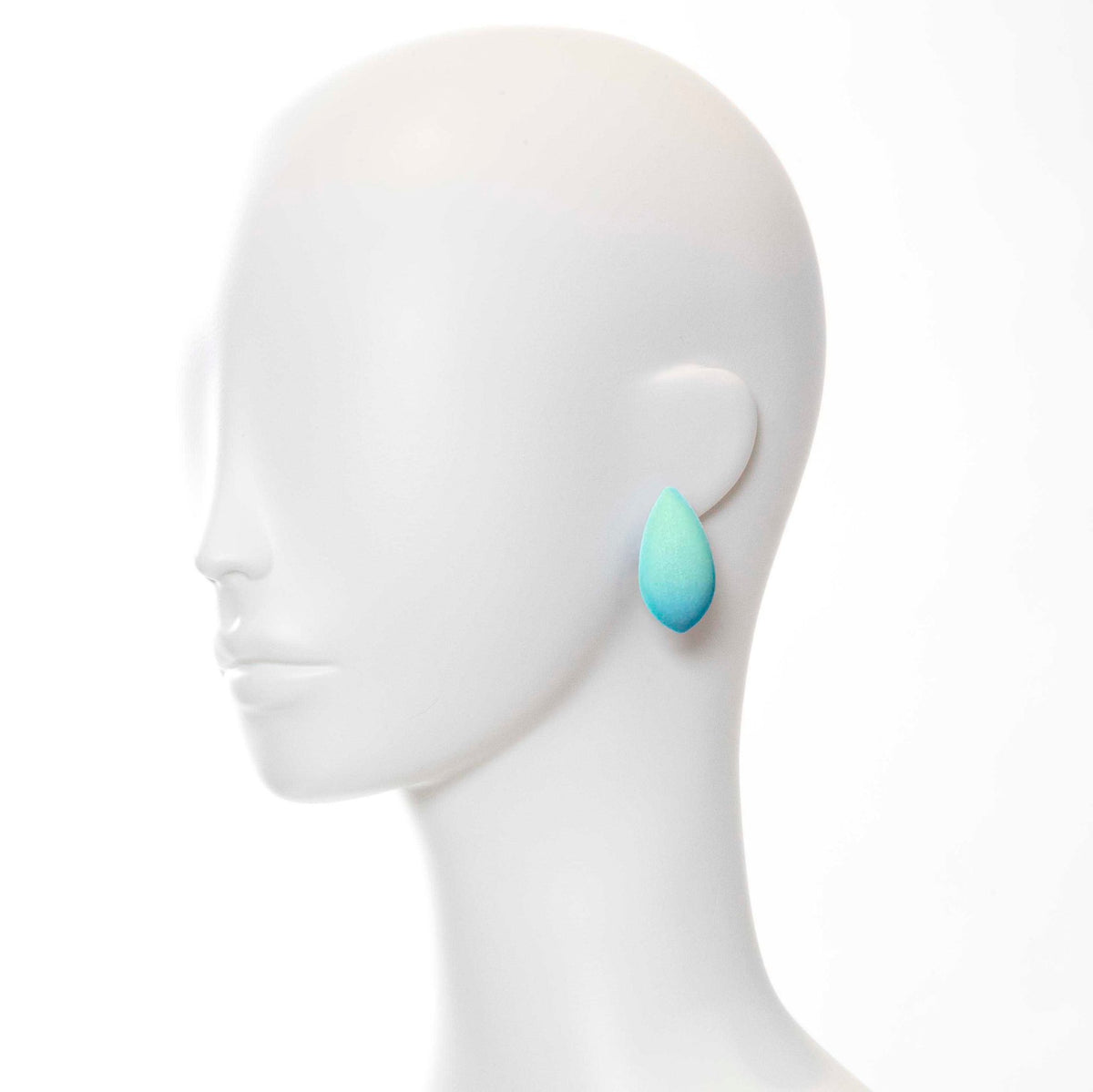 1. Mannequin wearing a single Tanel Veenre Mega Dream Day Earring in turquoise with velvety cosmic dust coating
