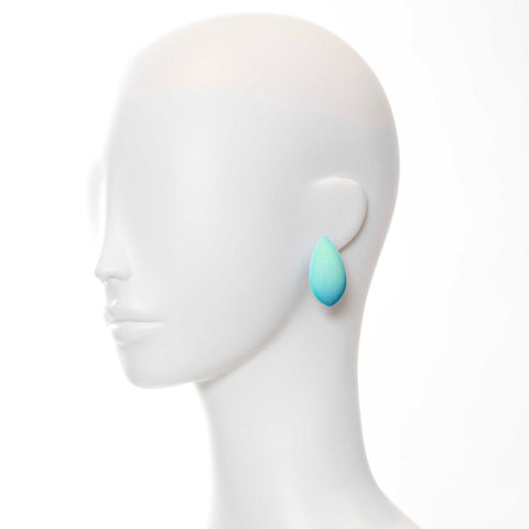 1. Mannequin wearing a single Tanel Veenre Mega Dream Day Earring in turquoise with velvety cosmic dust coating
