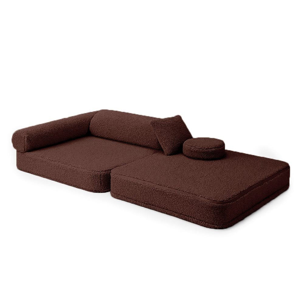 3. Dark brown modular children's chair laid flat with cushions and armrest on a white background